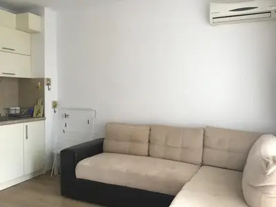 a living room with a couch and a kitchen at Casa del Mar Apartment in Obzor
