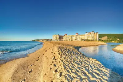 a view of a beach with a hotel in the background at Casa del Mar Apartment in Obzor