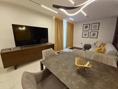 a living room with a large television and a couch at Diamond Beach Sarafovo by KP - Luxury Collection, Apt 5 in Burgas City