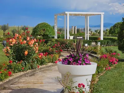 a garden with flowers and a gazebo at Diamond Beach Sarafovo by KP - Luxury Collection, Apt 5 in Burgas City