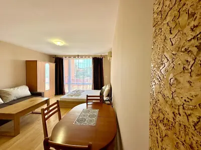 a room with a table and a room with a bed at Privilege Fort Beach - Menada Apartments in Elenite
