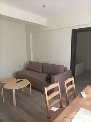 a living room with a couch and a table and chairs at Apartment Starfish in Varna City