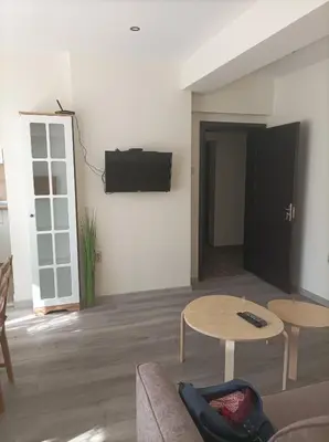 a living room with a couch and a tv on a wall at Apartment Starfish in Varna City
