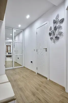 an empty room with a white door and a mirror at Weiss Estate by EstateAutomata in Burgas City