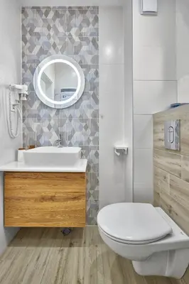 a bathroom with a toilet and a sink and a mirror at Miami Vibe by EstateAutomata in Burgas City