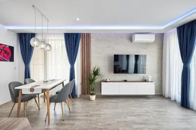a dining room with a white table and chairs at Miami Vibe by EstateAutomata in Burgas City