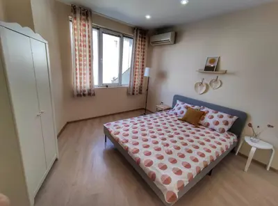 a small bedroom with a bed and a window at By The Cathedral, 1 bed flat in Varna City