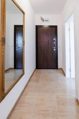 a hallway with a mirror and a wooden door at LifeStyle 6 in Sunny Beach