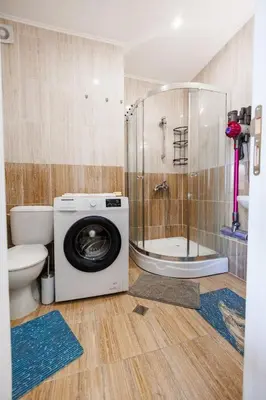 a bathroom with a washing machine and a toilet at LifeStyle 6 in Sunny Beach