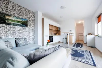 a living room with a couch and a kitchen at LifeStyle 6 in Sunny Beach