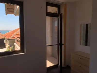 an open door to a room with a window at Sozopol Old Town - Guest House Fenix in Sozopol