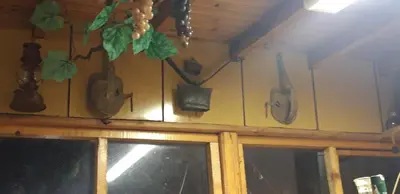 a wall with a bunch of utensils hanging on a wall at Krimski Guest House and Bungalows in Byala