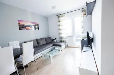 a living room with a couch and a tv at LifeStyle 6 in Sunny Beach