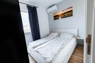 a white bed in a room with a window at LifeStyle 6 in Sunny Beach