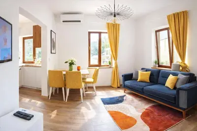 a living room with a blue couch and a table at Linden House Flat in Varna City