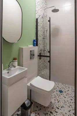 a bathroom with a toilet and a sink and a shower at Linden House Flat in Varna City