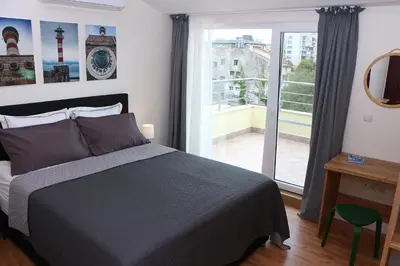 a bedroom with a bed and a large window at Shik & Chic in the Heart of Burgas # 5min from beach in Burgas City