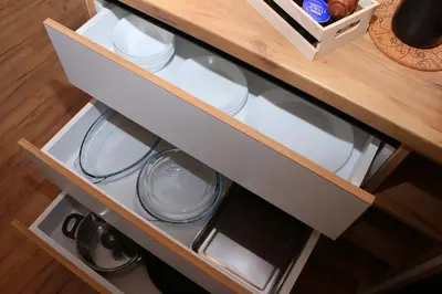 a drawer in a cabinet with white dishes in it at Shik & Chic in the Heart of Burgas # 5min from beach in Burgas City