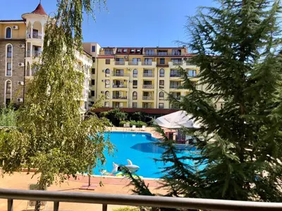 a swimming pool in front of a large building at Summer Dreams - Menada Apartments in Sunny Beach