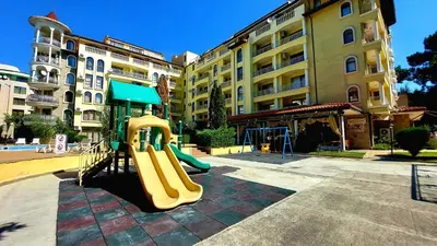 a playground with a slide in front of a building at Summer Dreams - Menada Apartments in Sunny Beach