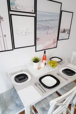 a dining room table with black and white plates at Central Cosy, Fully Renovated 2BD Near the Cathedral in Varna City
