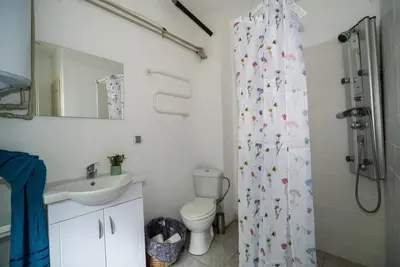 a bathroom with a sink and a shower curtain at Рибарник Forest Мagic in Topolitsa
