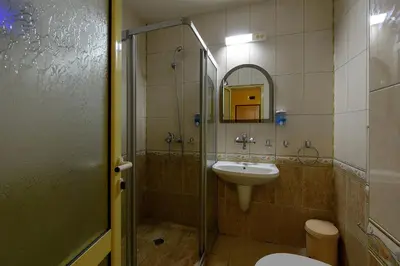 a bathroom with a sink and a shower and a toilet at Evridika Apartments in Nesebar