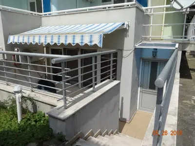 a building with a staircase leading to a door at Evridika Apartments in Nesebar