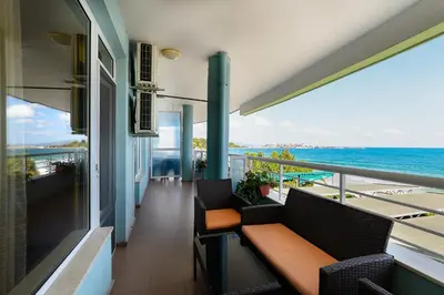 a balcony with a bench and a view of the ocean at Evridika Apartments in Nesebar
