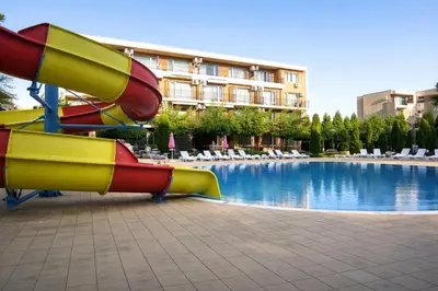 a water slide in front of a swimming pool at Nice family apartment in Sunny Beach