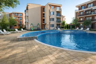 a swimming pool in a apartment complex with buildings at Nice family apartment in Sunny Beach