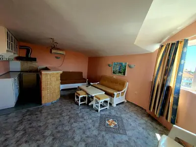 a living room with a couch and a table at Family Hotel Paros 2 in Pomorie