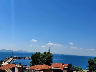 a view of a harbor with houses and the water at Family Hotel Paros 2 in Pomorie
