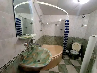 a bathroom with a sink and a toilet at Family Hotel Paros 2 in Pomorie
