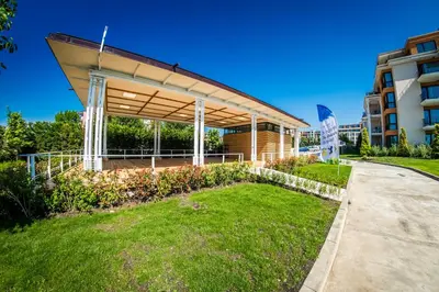 a building with awning in front of a building at Premier Fort Beach Hotel in Sveti Vlas