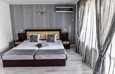 a bedroom with a bed with two pillows on it at Dimitur Jekov Guest House in Obzor