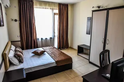 a hotel room with a bed and a window at Dimitur Jekov Guest House in Obzor