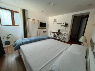 a bedroom with a large bed and a table at Vi Del Mar Apartments Varna in Varna City