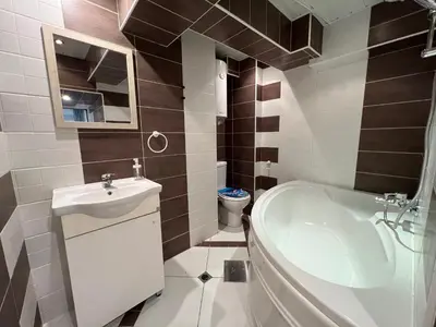 a bathroom with a sink and a toilet and a tub at Vi Del Mar Apartments Varna in Varna City