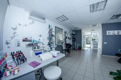 a room with a hair salon with a table and chairs at Nessebar and Holiday Fort Apartments in Sunny Beach