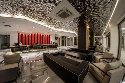 a lobby with couches and a red curtain at Premier Fort Beach Resort in Sunny Beach