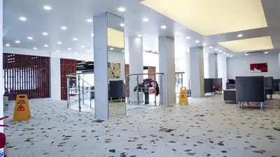 a large room with a lobby with chairs and a mirror at Grand Hotel Sunny Beach - All Inclusive in Sunny Beach