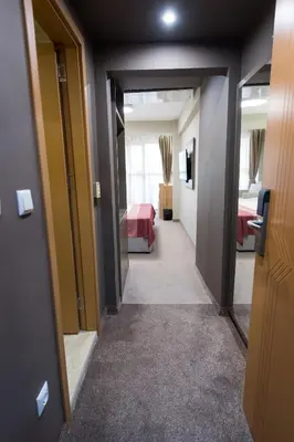 a hallway leading to a room with a bedroom at Grand Hotel Sunny Beach - All Inclusive in Sunny Beach