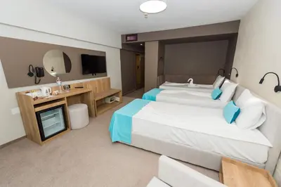 a hotel room with a bed and a tub at Grand Hotel Sunny Beach - All Inclusive in Sunny Beach