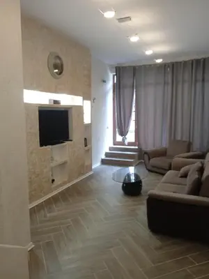 a living room with a couch and a flat screen tv at Апартаменти Стефанов in Varna City