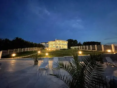 a large white building with lights in front of it at The Lodge Summer Apartments in Sozopol
