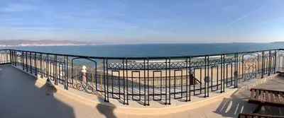 a balcony with a view of the beach and the ocean at Penthouse Happy Moments in Sunny Beach