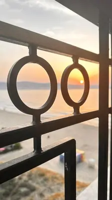 a view of the ocean from a balcony with a fence at Penthouse Happy Moments in Sunny Beach