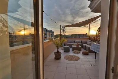 a view of a patio with a couch on a balcony at Messembria Resort in Sunny Beach
