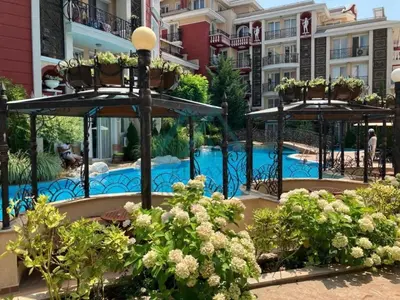 a resort with a swimming pool and some buildings at Messembria Resort in Sunny Beach